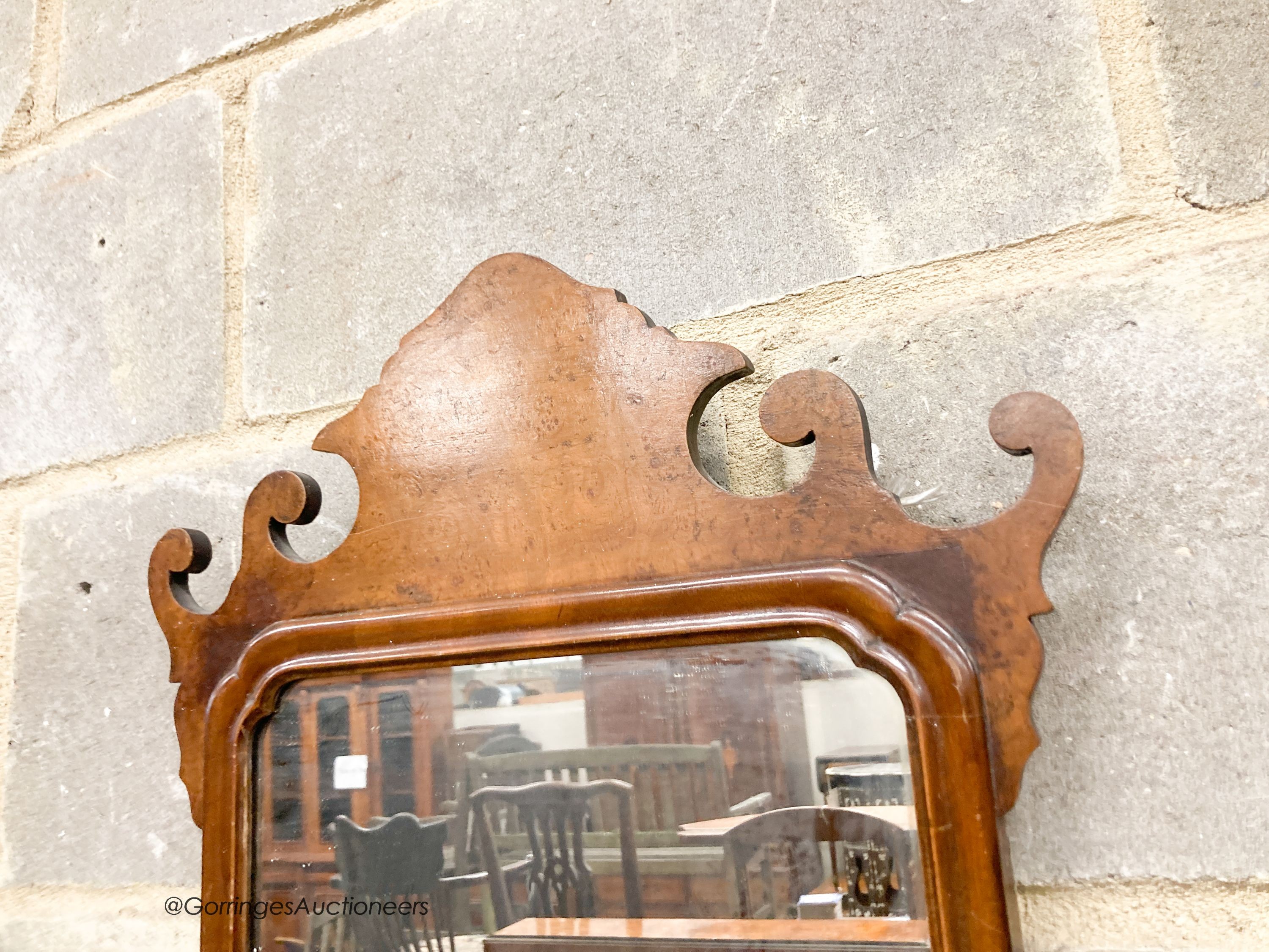 A pair of 18th century style walnut fret cut wall mirrors, width 42cm, height 70cm